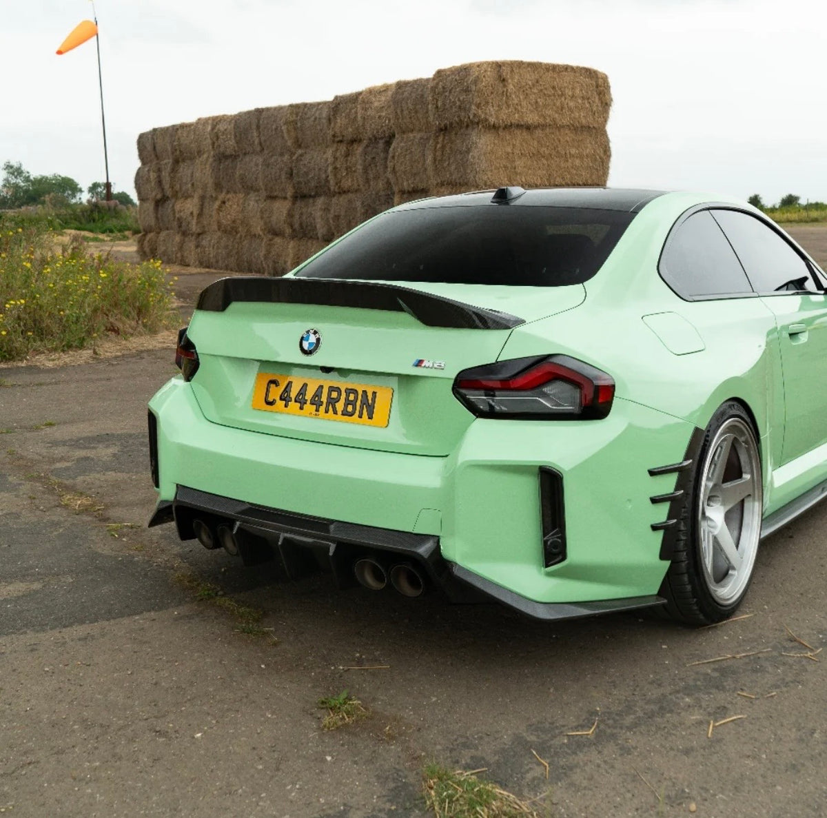 Grüner BMW M2 G87 mit CPG + V6 Dry-Carbon Heckdiffuser – schräge Heckansicht