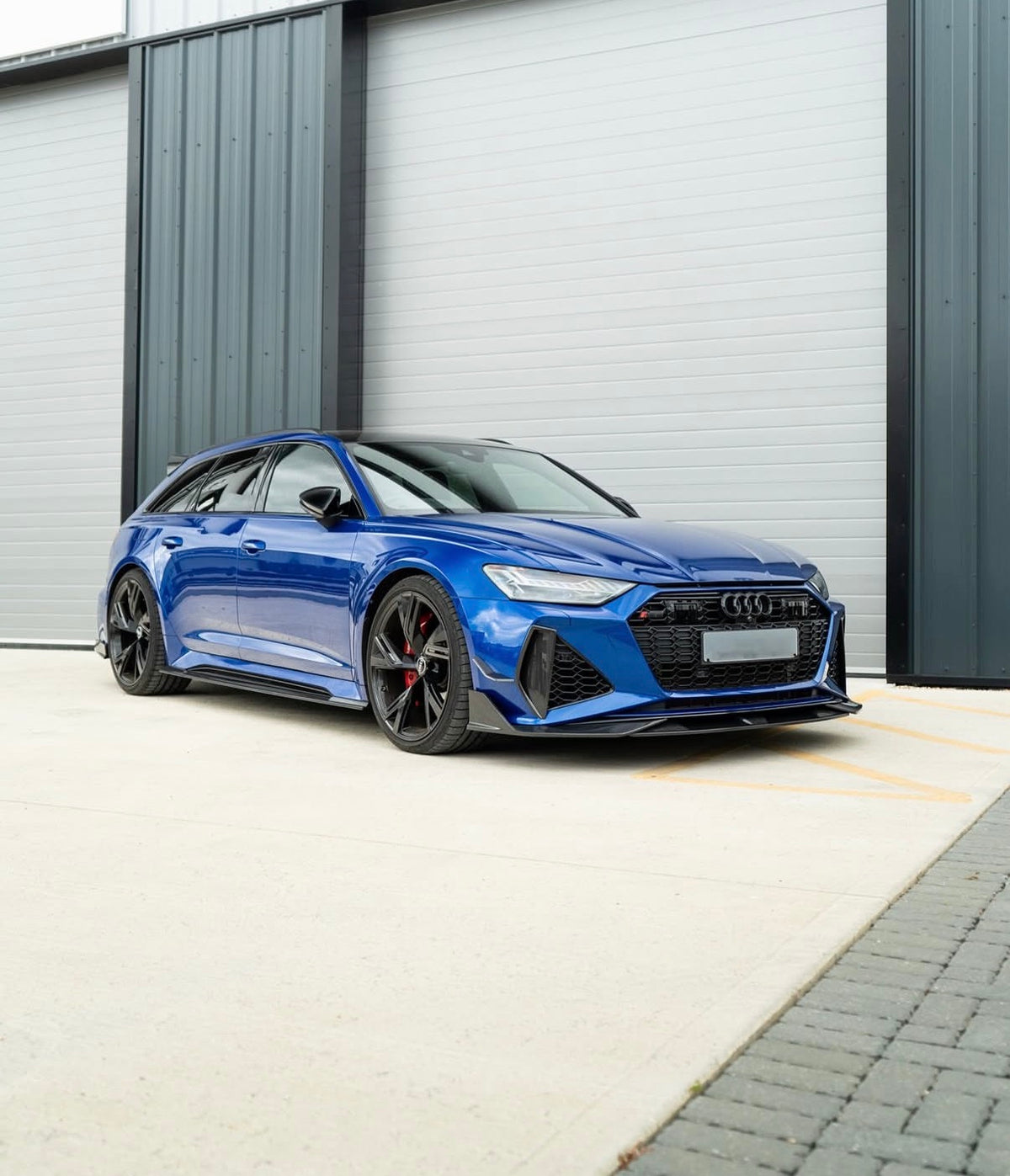 Sportliche Seitenansicht eines blauen Audi RS6 C8 mit V1 Stoßstangen-Lufteinsätzen
