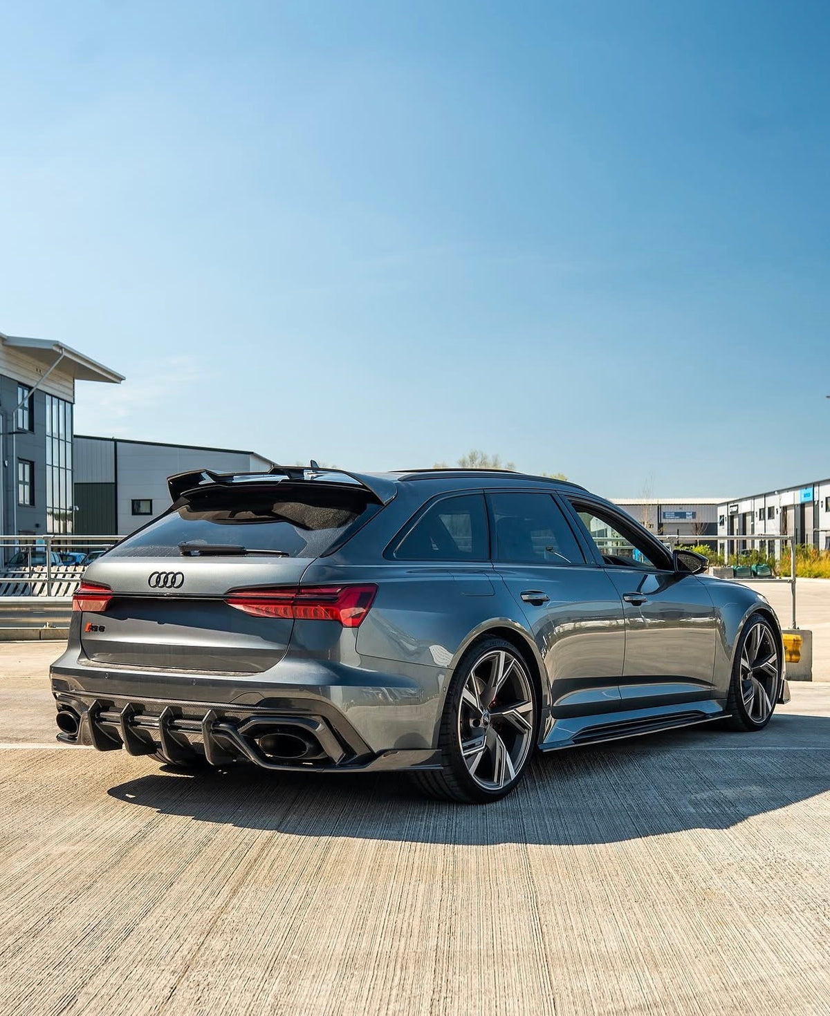 Grauer Audi RS6 C8 Avant mit montiertem CPG + V1 Carbon Heckdiffuser in der Heckseitenansicht