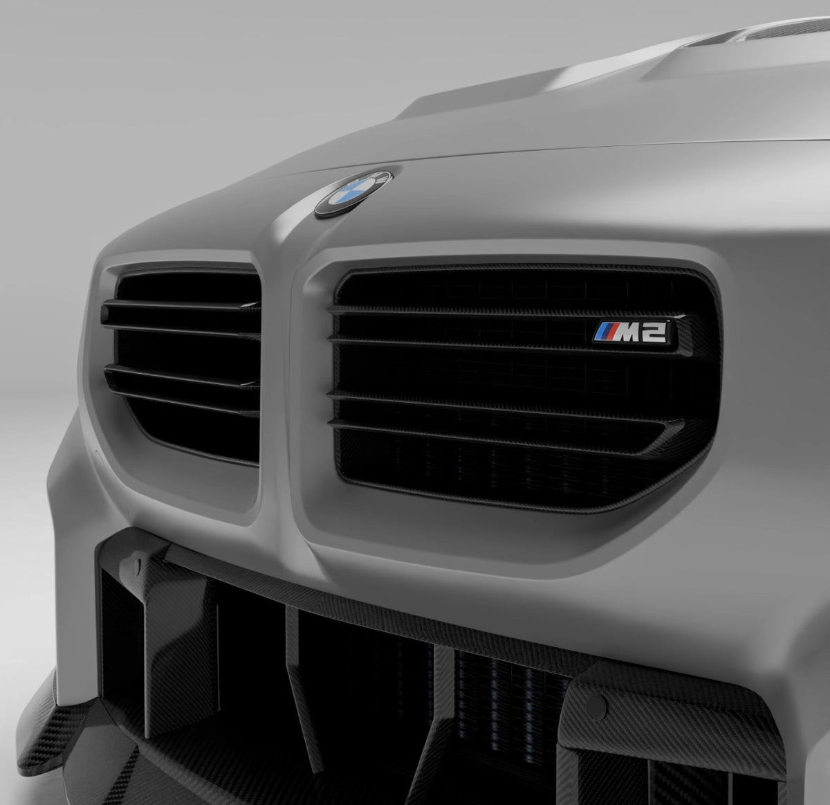 Weißer BMW M2 G87 mit montiertem RV V1 Carbon Kühlergrill in Nahaufnahme.