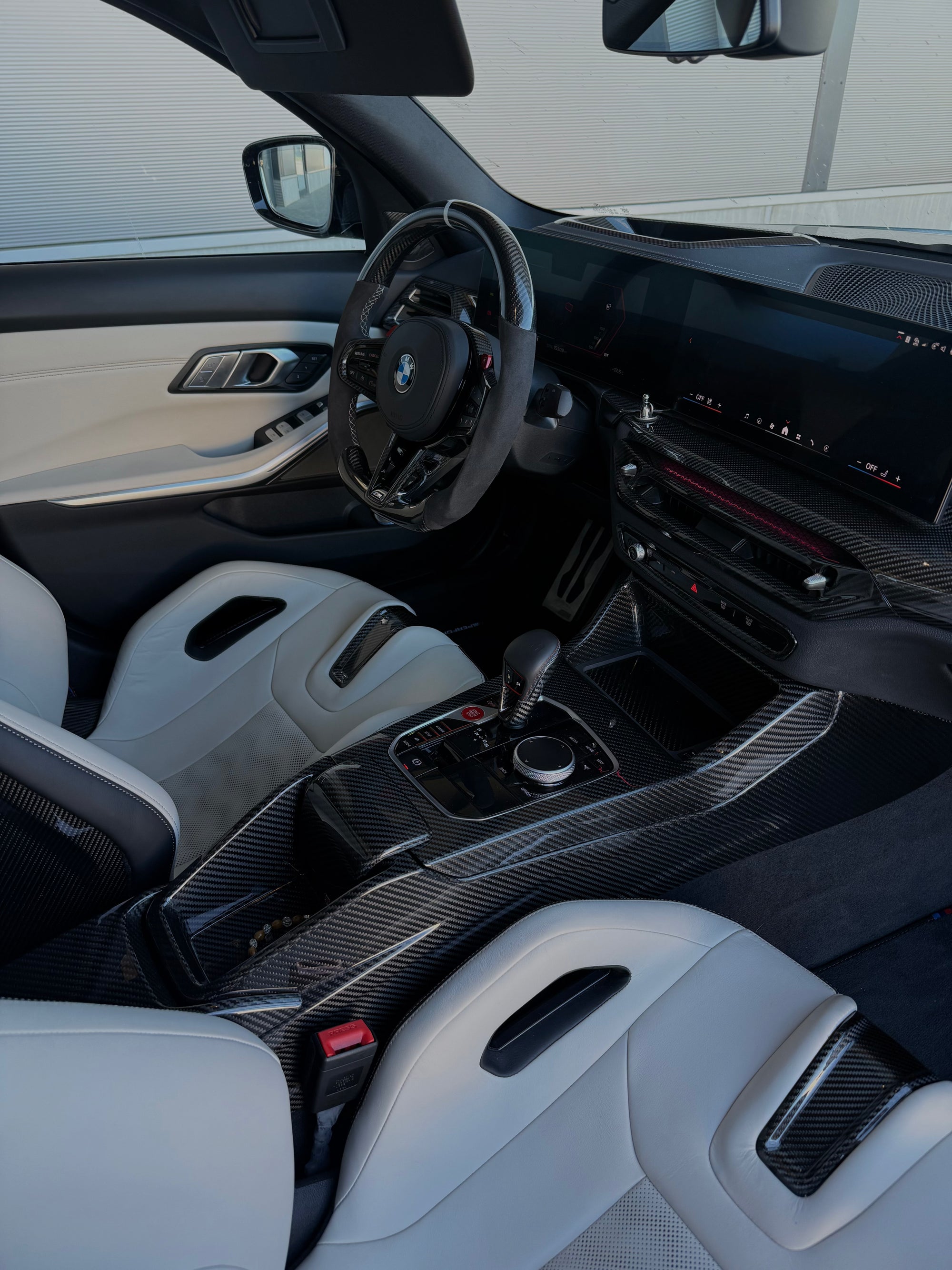 CPG+ V1 Carbon-Lüftungsverkleidung im BMW M Innenraum mit iDrive 8.5 – Ansicht von der Beifahrerseite